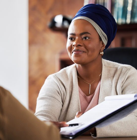 A woman pointing to paperwork with a pen